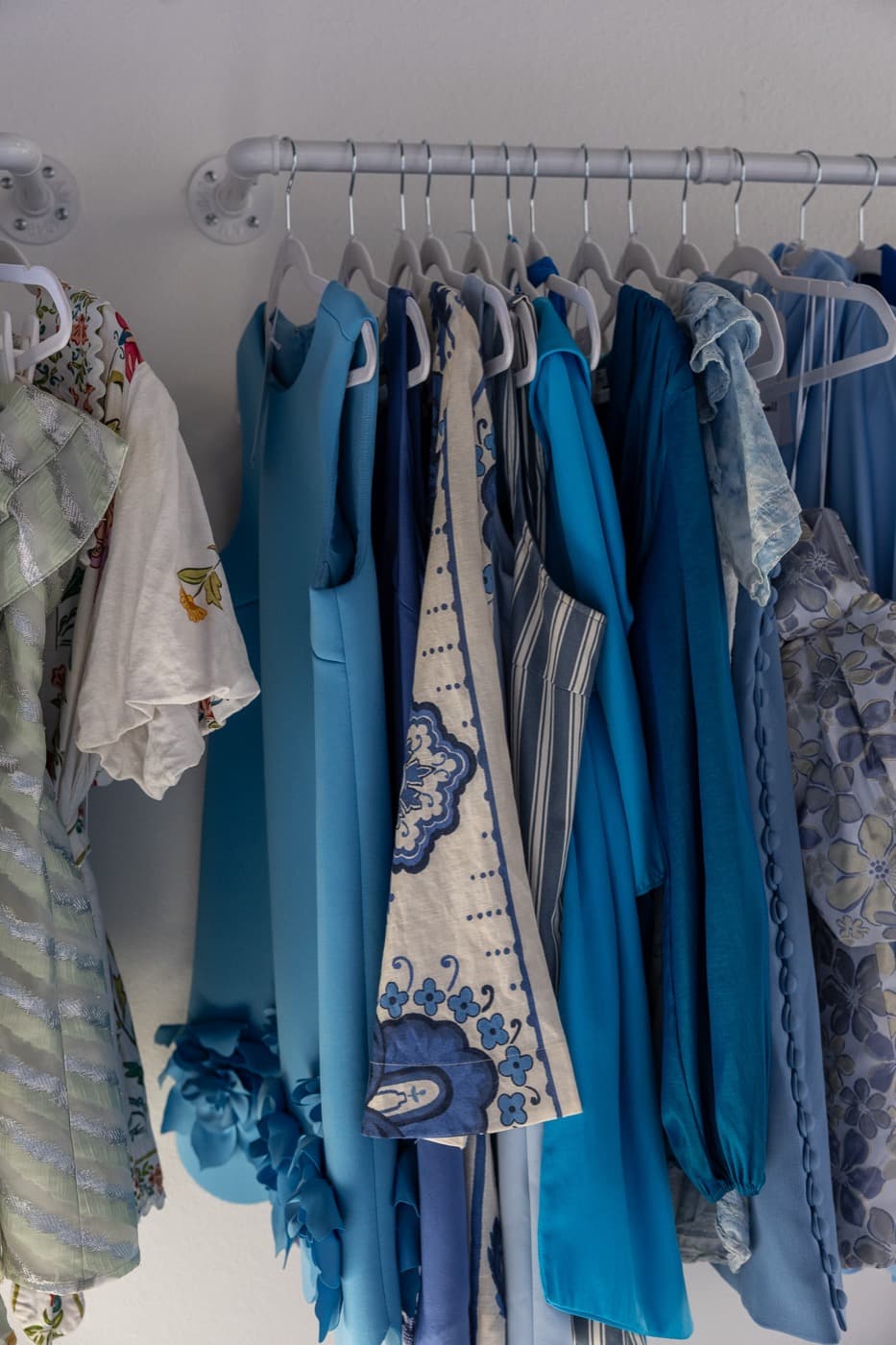 A rack of blue dresses, tonal and elegant