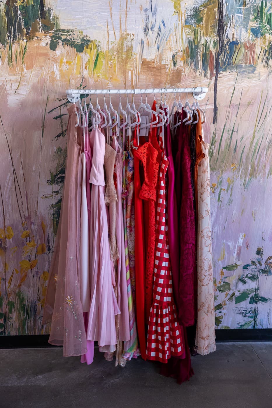 Pinks and reds gathered against the landscape mural